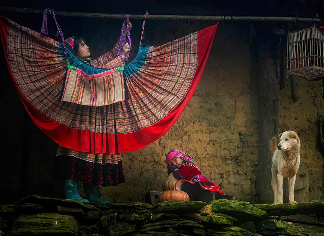 Hmong woman wearing traditional clothing and handmade textiles in Sapa Vietnam