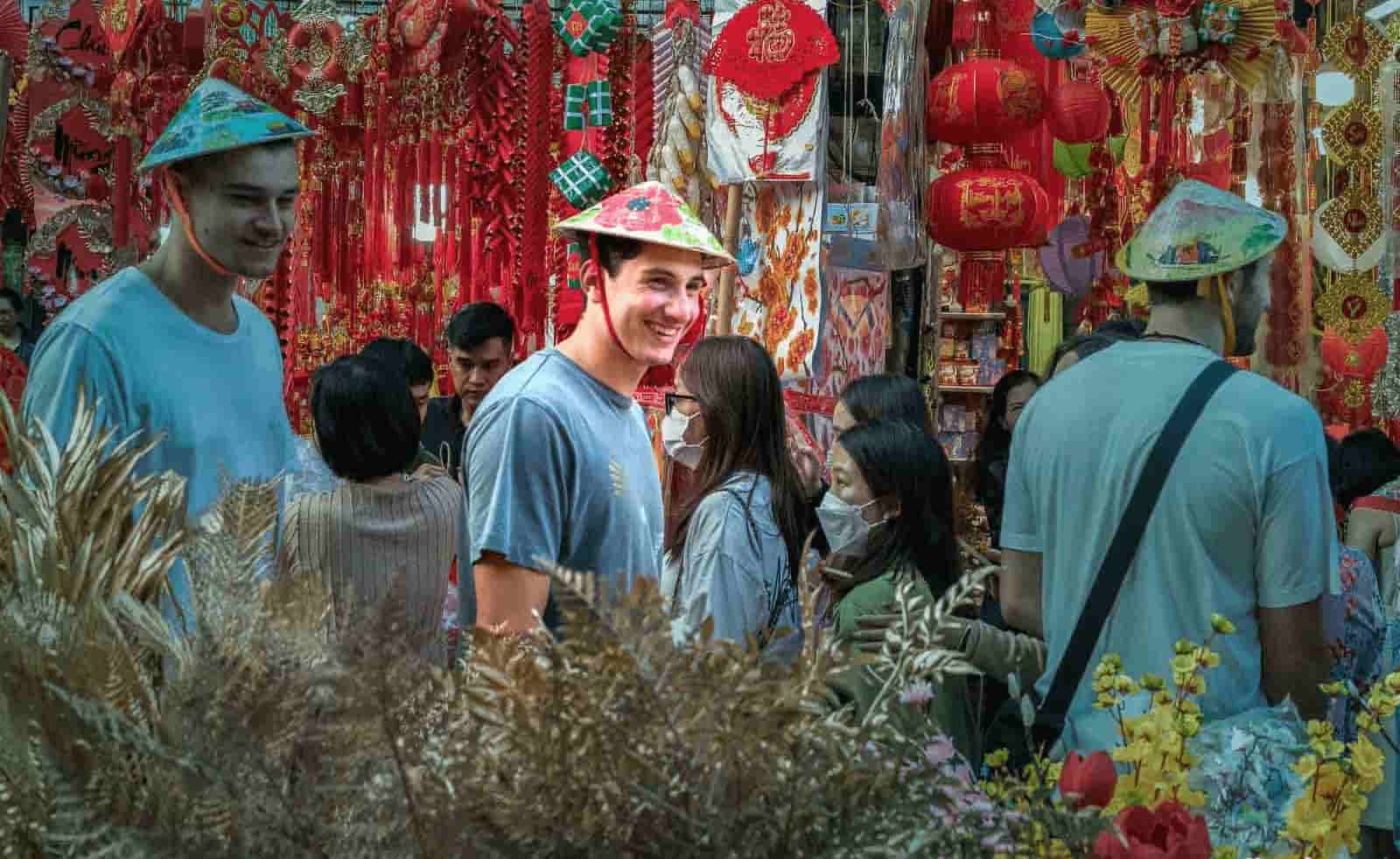 Travelers exploring Hanoi Old Quarter with traditional shops and local culture in Vietnam
