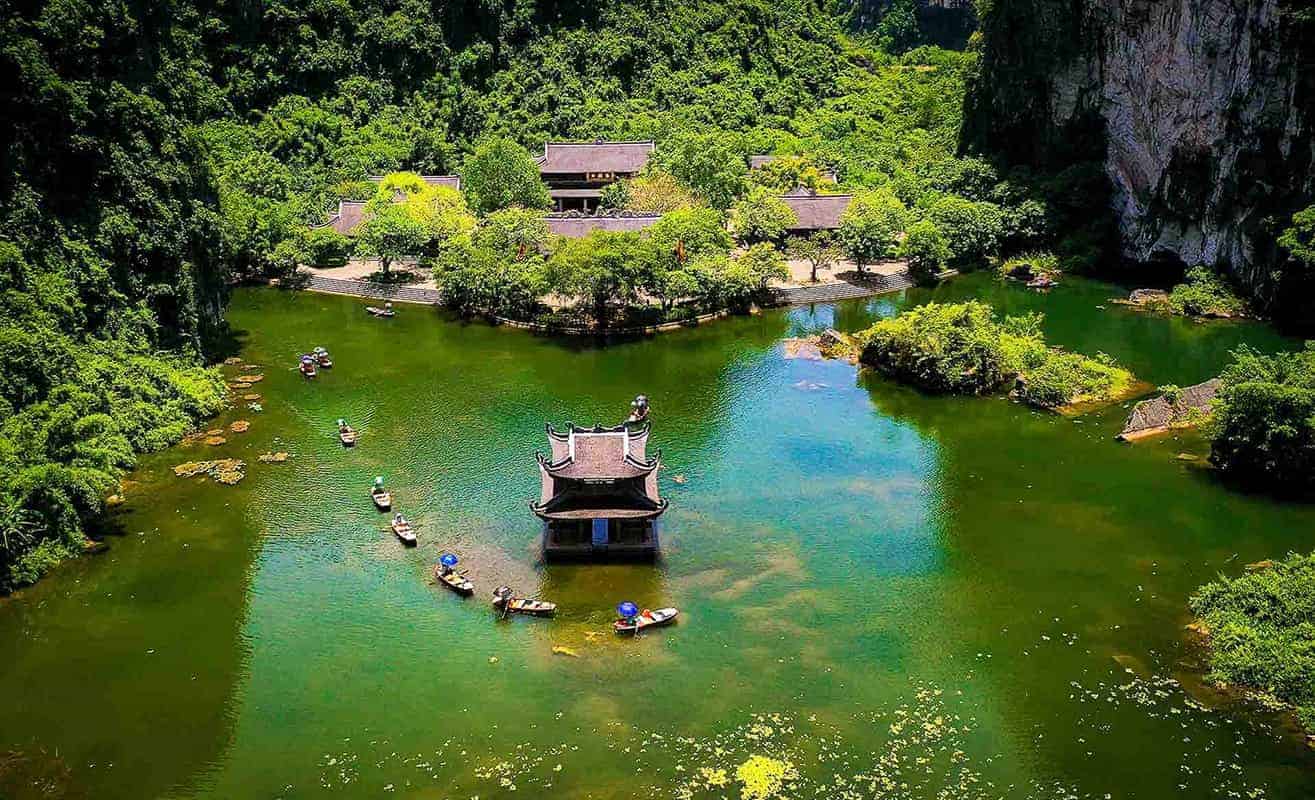 Trang An Ninh Binh boat ride with limestone mountains and green water in Vietnam