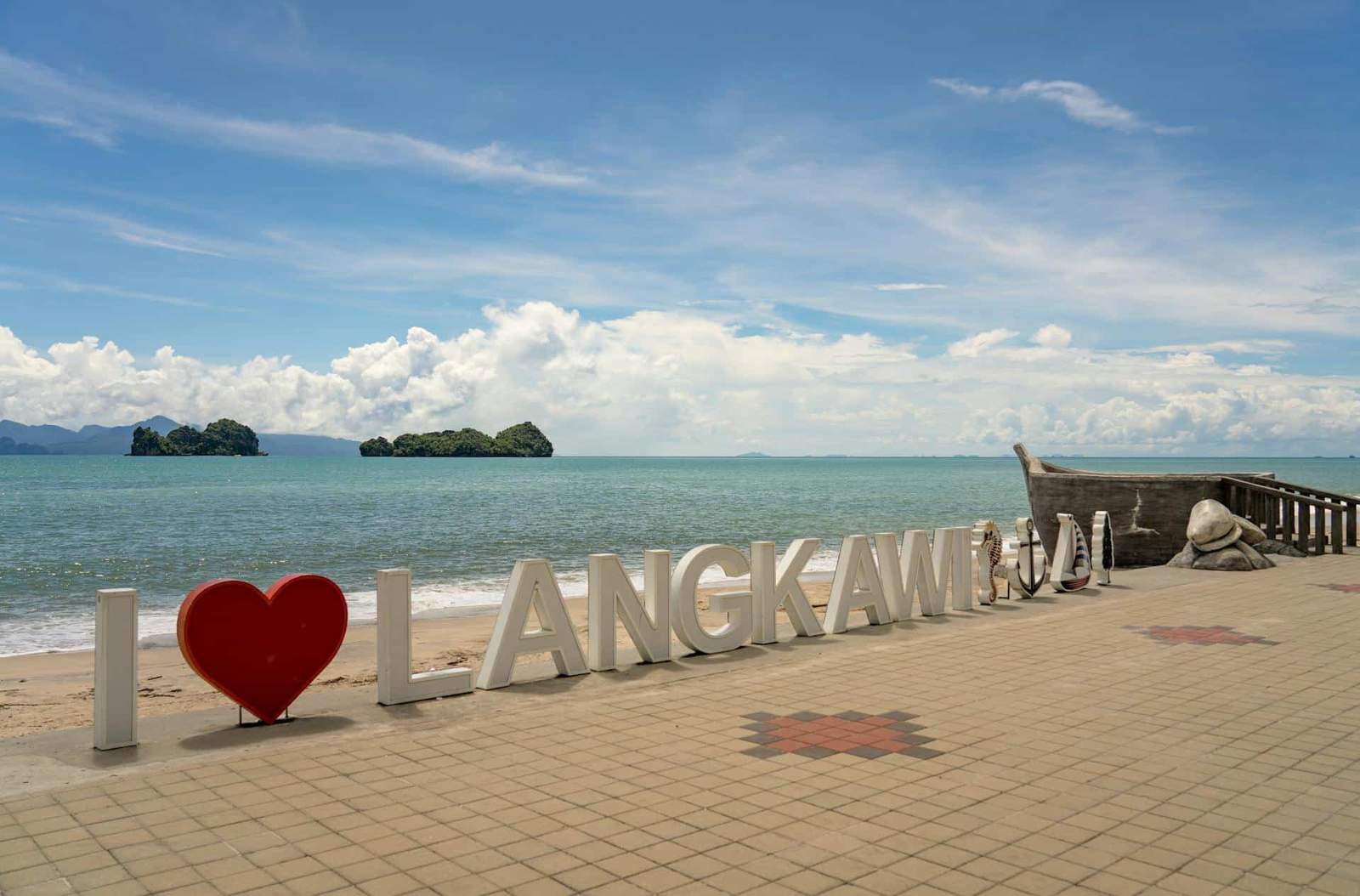 I love Langkawi sign at the beach with ocean view and islands in the background.