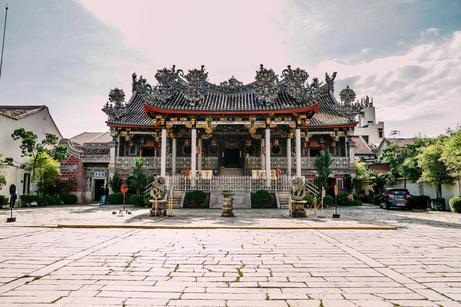 Traditional Chinese temple with ornate roof and intricate carvings in a historic setting.