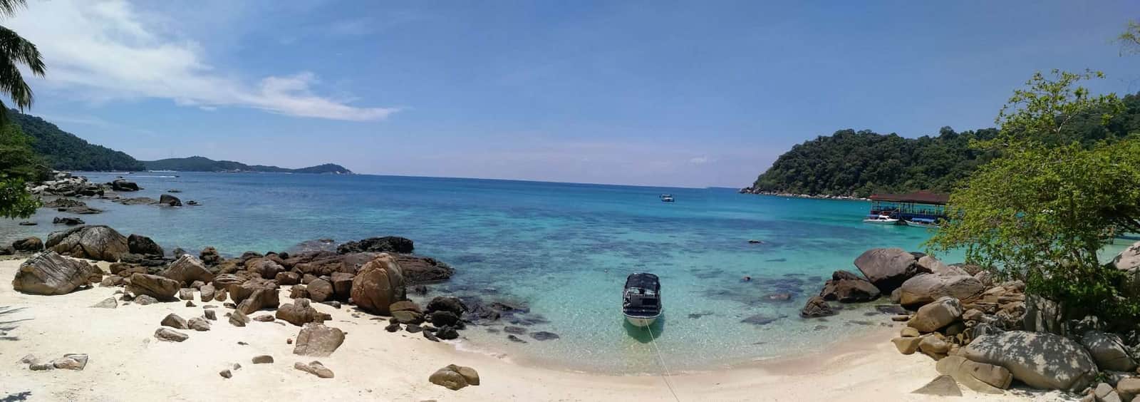 Beautiful tropical beach with turquoise waters and rocky shoreline, perfect for relaxing vacations a.