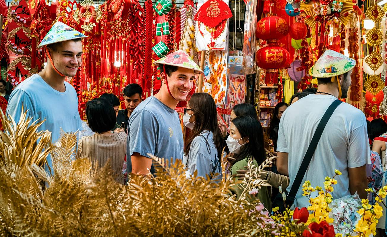 Travelers exploring Hanoi Old Quarter with traditional shops and local culture in Vietnam