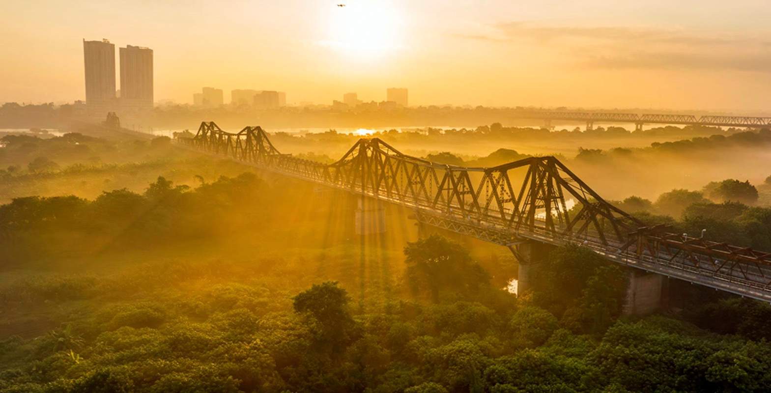 Long Bien Bridge over the Red River at sunrise in Hanoi Vietnam