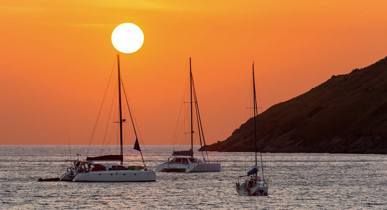 Sailboats at sunset along the Pattaya coastline, Thailand