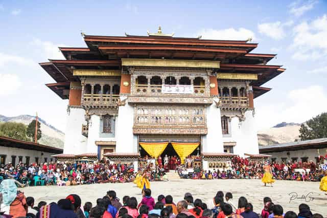 Masked dances at a tsechu festival in a dzong courtyard